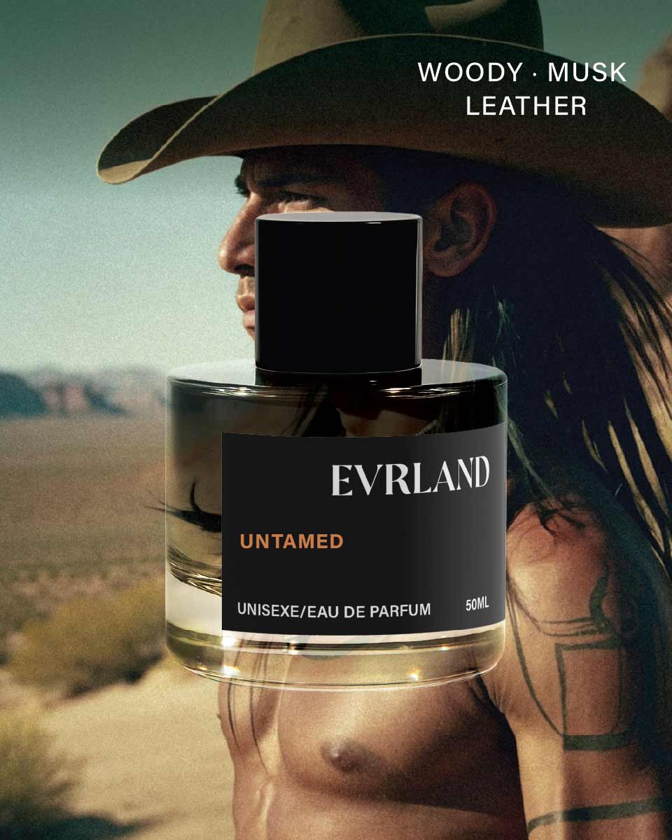 Perfume bottle labeled 'Evrland' with a person wearing a cowboy hat in the background